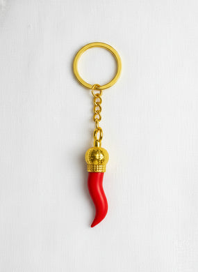 Red keychain with gold accents on a white background