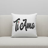 White pillow with 'Ti amo' text on a gray couch